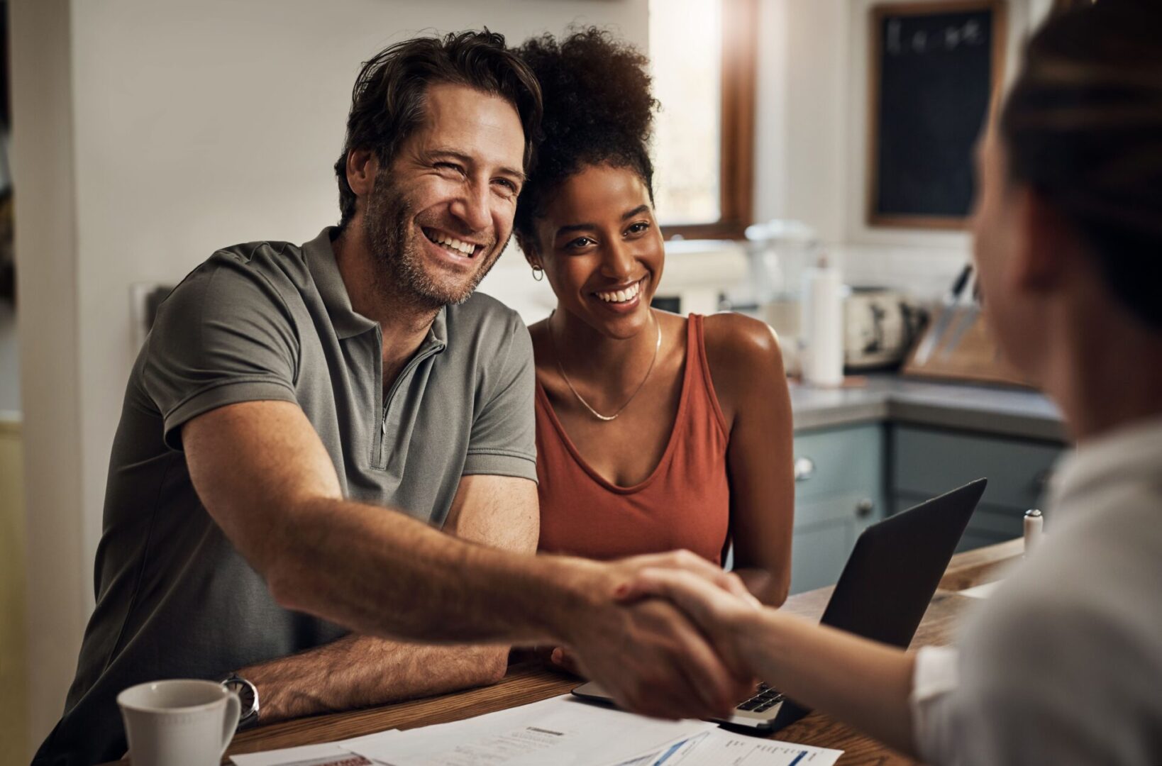 Couple shaking hands with a realtor.