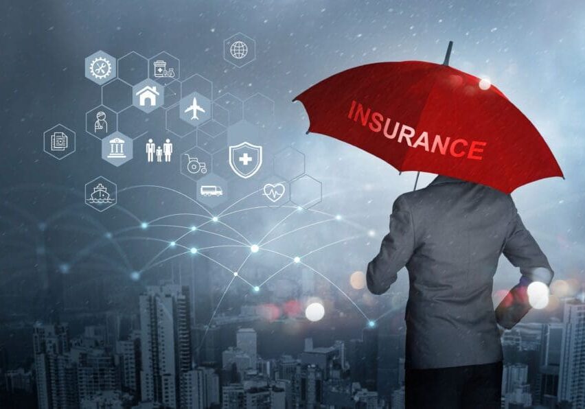 Businessman with red umbrella holding insurance.